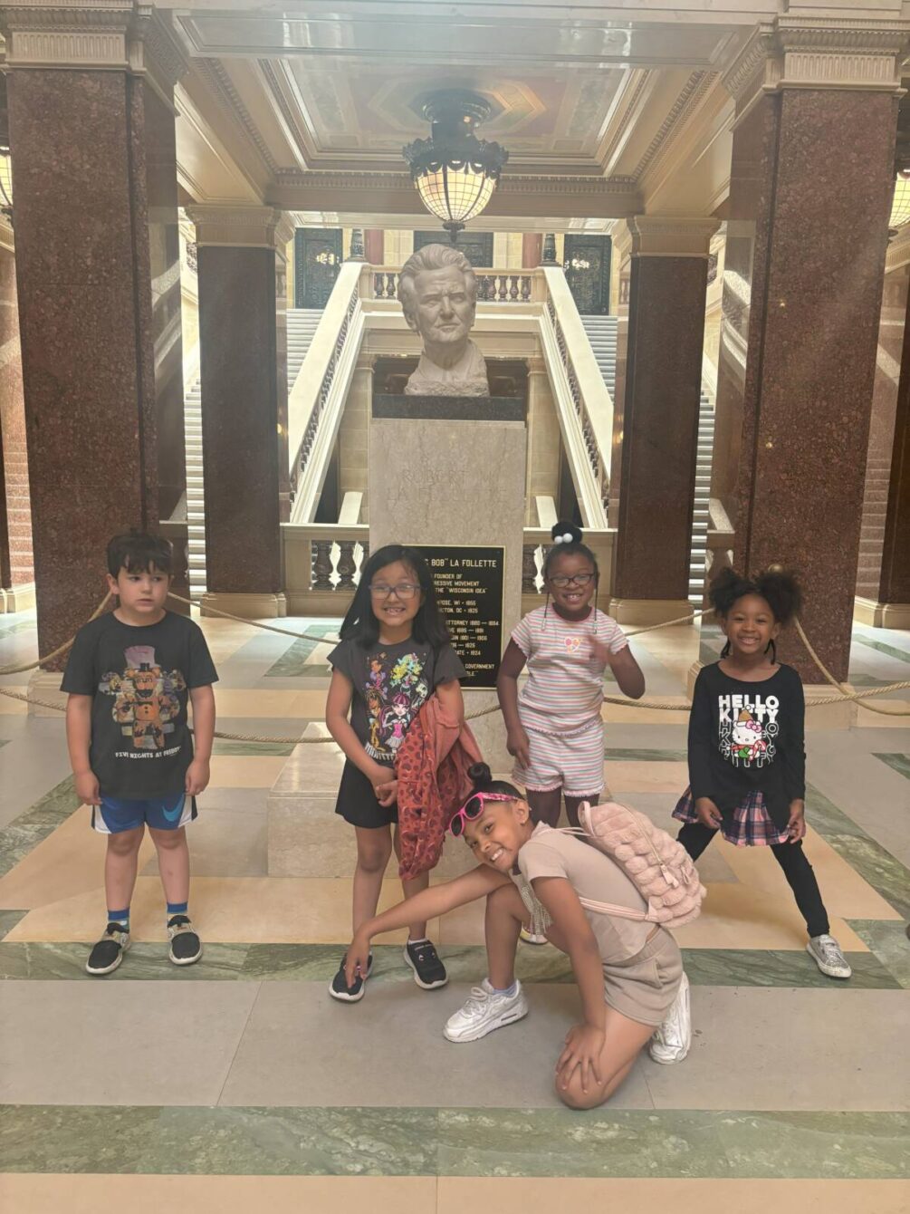 Kids posing in front of bust at Capital Building