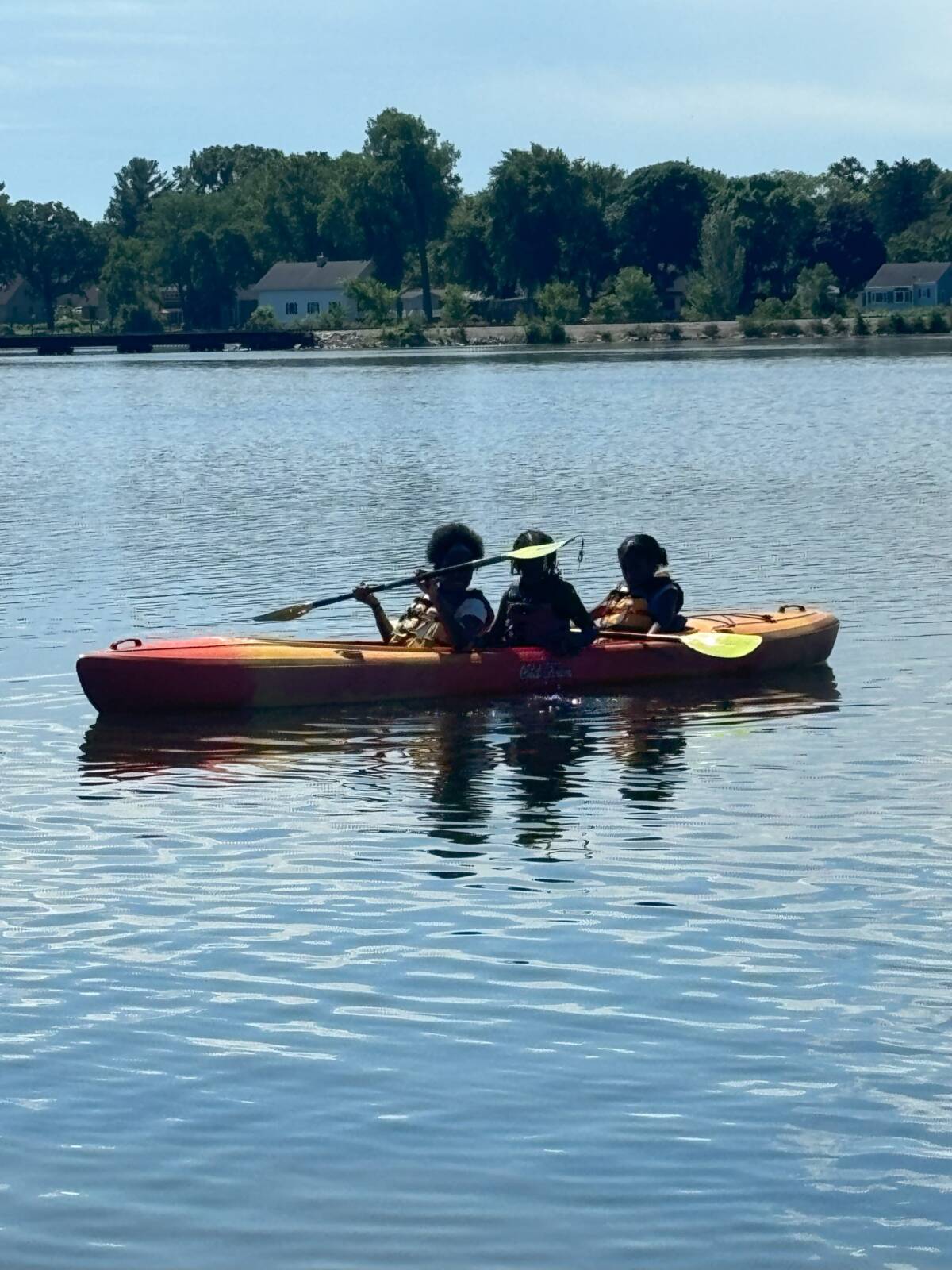 People riding canoe on lake