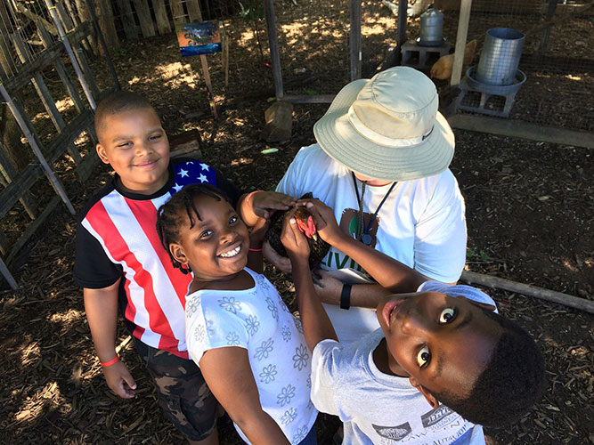Kids petting chicken