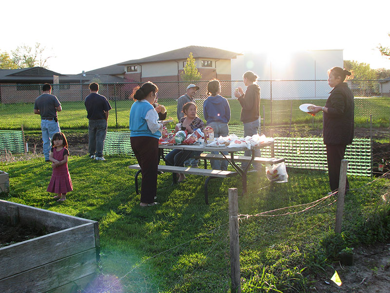 People gathering around community garden at East Madison Community Center